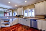 Fully Equipped Kitchen Features Gas Range, Double Ovens, and Bar Seating for 3